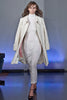 Generously cut 3/4 length coat with large rounded collar and covered buttons in off white, with a slight military feel. Features neo-classical trim design which naturally becomes fuzzy over time as a design detail. Size 12