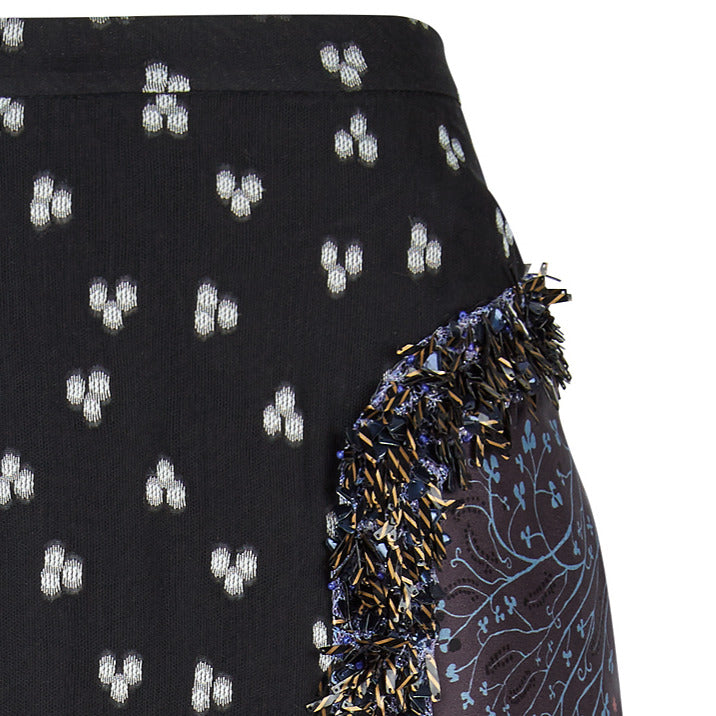 3/4 length skirt in sheer black with white geometric fabric design. Print on side panels featuring embellished linear sequin trim on side front panels. 00% Polyester. Contrast: 48% Polyester, 34% Cotton, 18% Nylon Dry Clean Only. Made in England